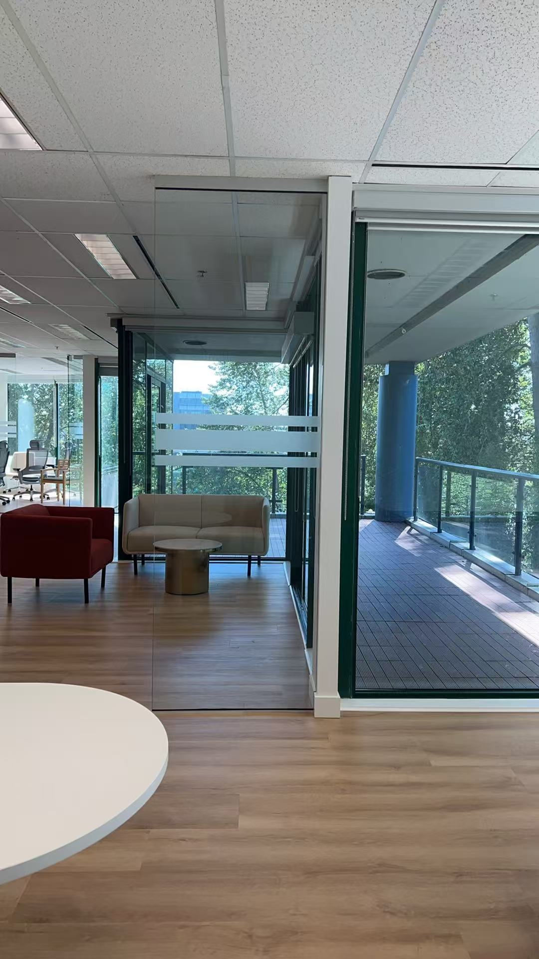 Office lounge seating beside large windows